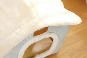 Detail view showing the soft plush texture and premium brand tag of the pet bed house.