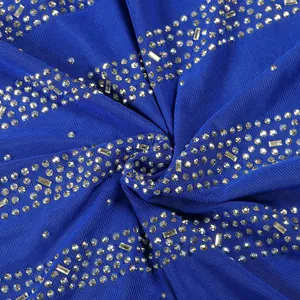 Detailed macro view of royal blue mesh fabric featuring sparkling silver rhinestone stripe patterns