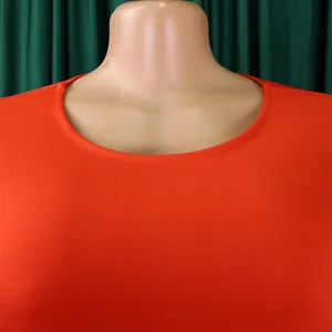Detail view of the round neckline and fabric texture of the orange plus size dress