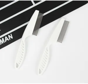Close-up detail of two professional white pet flea combs with fine stainless steel teeth