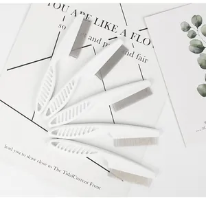 Detailed view of five white fine-toothed pet flea combs with stainless steel pins for dogs