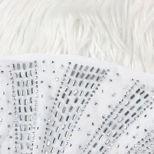 Macro detail view of sparkling silver rectangular rhinestones on white mesh evening dress