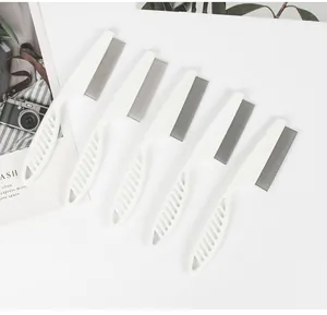 Detailed macro view of multiple white pet flea combs with fine metal teeth arrangement