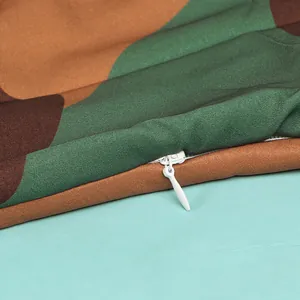 Close-up view of a white invisible zipper detail on a camouflage pattern fabric dress