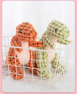 Close-up detail of textured plush dinosaur squeaky chew toys for dogs in a basket