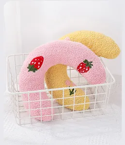 Soft plush U-shaped pet neck pillows with cute strawberry embroidery in a white basket
