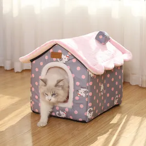 Warm house-shaped cat bed with plush pink roof and grey polka dot pattern in a home setting