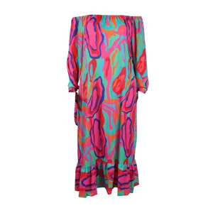 Detail of a colorful off-the-shoulder maxi dress featuring vibrant abstract patterns