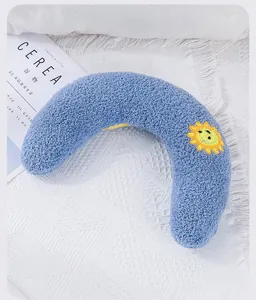 Detail view of the soft blue plush U-shaped pet pillow with sun embroidery design