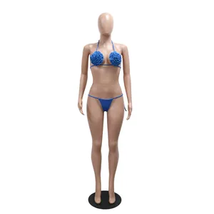 Blue bikini set featuring 3D floral ruffles and halter tie design on mannequin