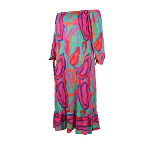 Detail view of vibrant abstract print on an off-shoulder long sleeve maxi dress
