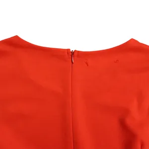 Macro detail view of the high-quality invisible back zipper on a red plus size dress