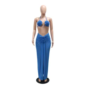 Detailed close-up view of 3D floral accents and fabric texture on a blue halter bikini set