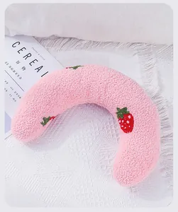 Soft plush U-shaped pet pillow with cute strawberry embroidery for neck protection.