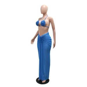 Detailed view of blue bikini three-piece set with 3D floral accents and long skirt