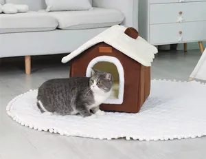 Cozy brown and white house-shaped cat bed placed on a plush white rug in a living room