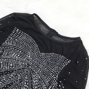 Close-up of black mesh evening dress with intricate silver rhinestone embellishments.