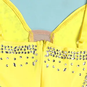 Close-up of yellow rhinestone evening dress with invisible zipper and mesh detail