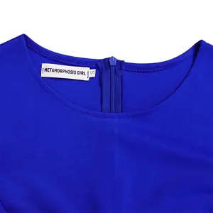 Detail of bright blue dress neckline with zipper and Metamorphosis Girl brand tag
