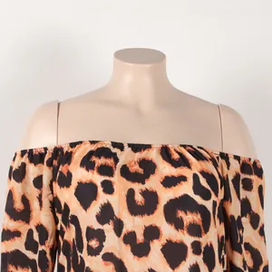 Close-up detail of sexy off-the-shoulder leopard print dress with bold patterns