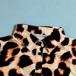 Close-up detail of a slim-fit lapel dress with bold leopard print pattern