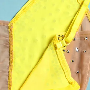 Close-up of yellow sheer evening dress with sparkling rhinestones and strap detail.