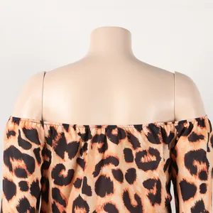 Detailed macro view showing the leopard print pattern and off-shoulder neckline of the dress