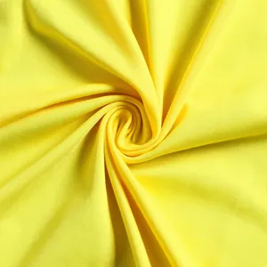 Macro detail shot showing the soft texture of bright yellow stretch fabric for evening dress
