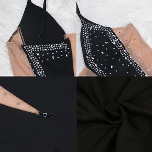 Detailed close-up of rhinestone embellishments and fabric texture on a sheer black dress.