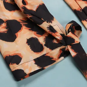 Close-up of leopard print fabric detail and tie knot on a slim fit dress