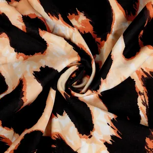 Macro detail of vibrant orange and black leopard print fabric for clubwear dress