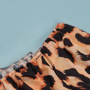 Macro close-up detail of a sexy leopard print dress showing elastic waist stitching texture