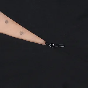 Macro detail of a high-quality invisible zipper on a sexy black mesh perspective dress.