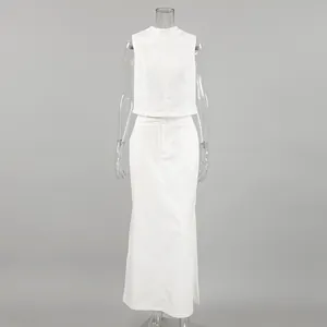 Minimalist white two-piece summer set featuring a sleeveless crop top and long skirt.