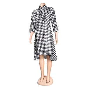 Detailed view of the houndstooth pattern and high-low hem on this collared midi dress