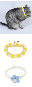Handcrafted knitted pet collars with colorful pom-poms and flower details for cats and dogs
