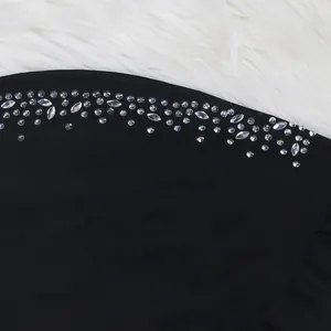 Close-up detail of shimmering rhinestones on black dress fabric