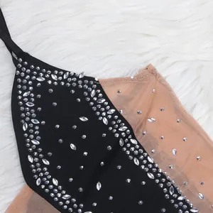 Close-up detail of a sexy black and nude mesh dress with sparkling silver rhinestones