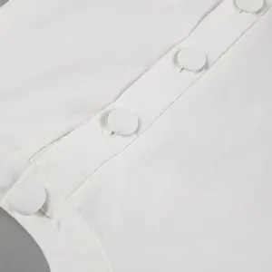 Close-up detail of fabric-covered buttons on a white cotton-linen summer vest set.