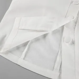 Close-up detail of white linen-cotton skirt set showing buttons and neat stitching