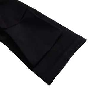Close-up detail of the sleeve cuff on an elegant black plus size long sleeve dress.