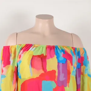 Close-up detail of off-the-shoulder neckline on a colorful abstract print dress on mannequin
