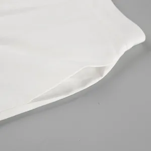 Close-up detail of white cotton linen fabric showing the side pocket seam stitching