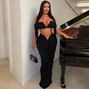 Sexy black two-piece set with strapless crop top and draped pleated floor-length skirt