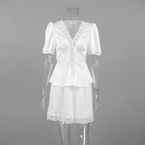 Front view of white satin two-piece skirt set with lace trim on a mannequin