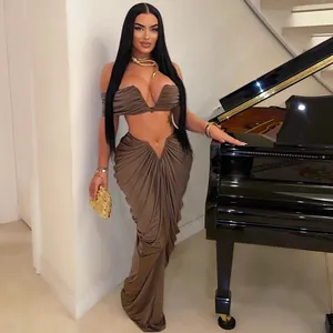 Sexy brown draped two-piece set with strapless crop top and pleated floor-length skirt.