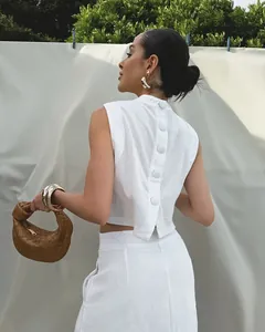 Detailed back view of a white cotton linen sleeveless top featuring elegant button accents
