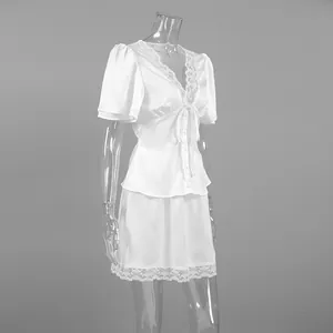 Side view of white satin two-piece set with lace trim and bow tie detail.