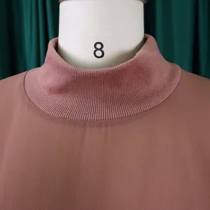 Detail view of a mauve chiffon dress showing the elegant ribbed mock neck collar