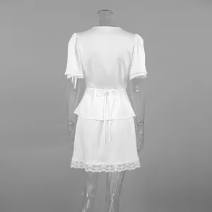 Elegant white satin two-piece set with a lace trim skirt and v-neck back detail.